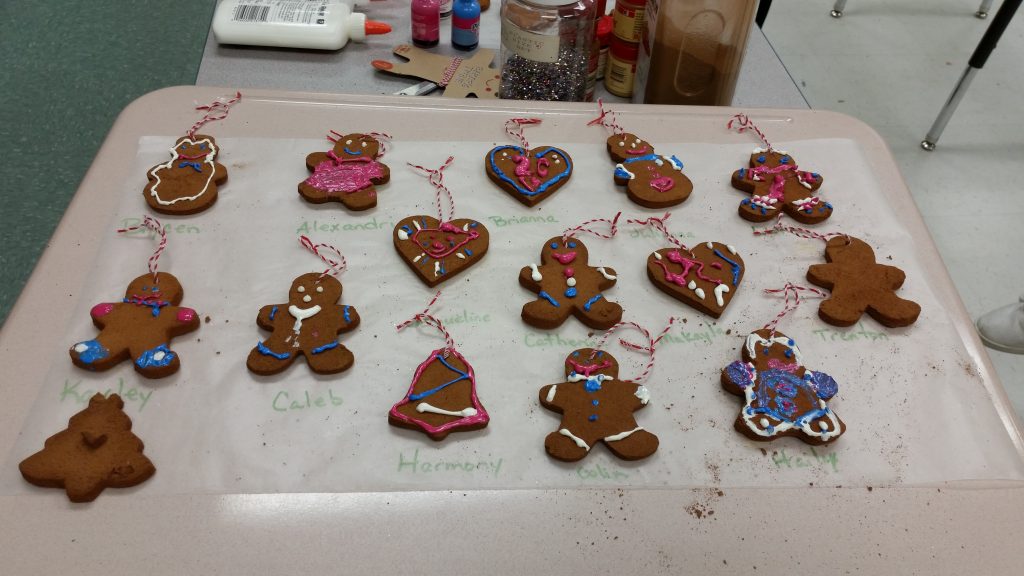 Use puffy paint to add decorations to your cinnamon ornament. This makes them look like special christmas cookies!