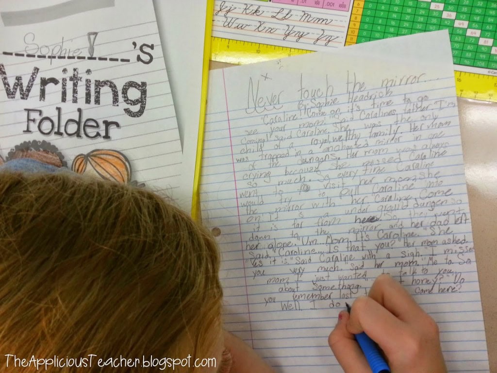student writing folder