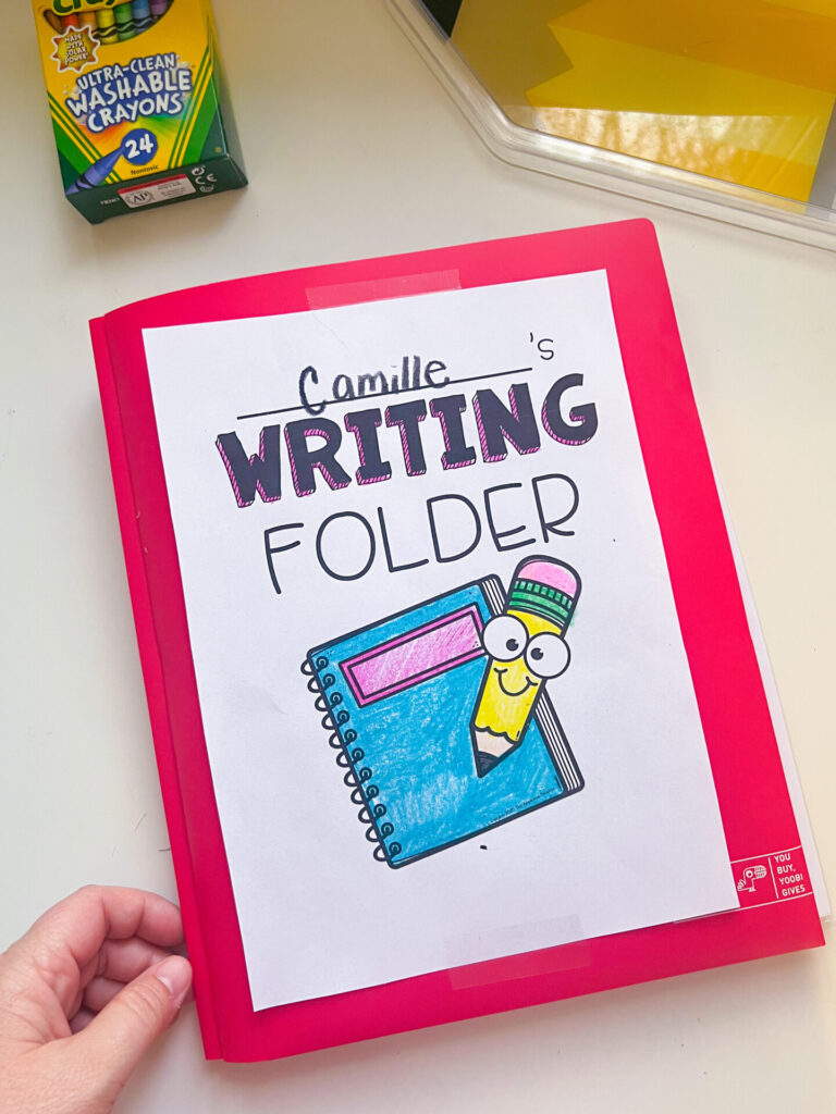 student writing folder
